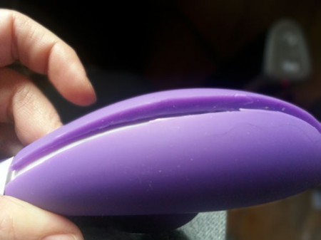 Photo shows a Lelo Ina with a visible slice through the silicone skin down the backside of the toy. You can see that the silicone skin isn't very thick, ranging from 2mm at the thinnest section to 5mm at the thickest. 