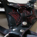 Tantus Black Widow Connoisseur Harness - Front panel with interchangeable rubber o-ring and 3 leather snaps