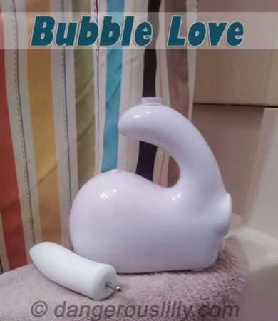 The Bubble Love and Dilly sitting on the edge of a bath tub