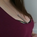 showing the Crave Vesper resting atop my cleavage, sticking out at a weird angle. The chain needs to be a lot longer. 