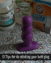 13 Tips to remove odors from your butt plug - photo shows a purple butt plug on a kitchen towel with coconut oil, vinegar and baking soda containers in the background