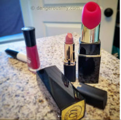 Womanizer 2GO next to some regular-sized cosmetics. It dwarfs everything.