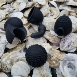 Four black O-Wand attachments on a bed of oyster shells