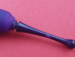 Close-up image of the broken Zumio - the plastic tip slightly separated from the body, with a lighter purple spot in the center of the tip, indicitative of where it bent