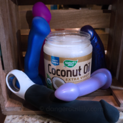 Coconut Oil and Silicone Sex Toys - A jar of coconut oil is surrounded by various silicone sex toys